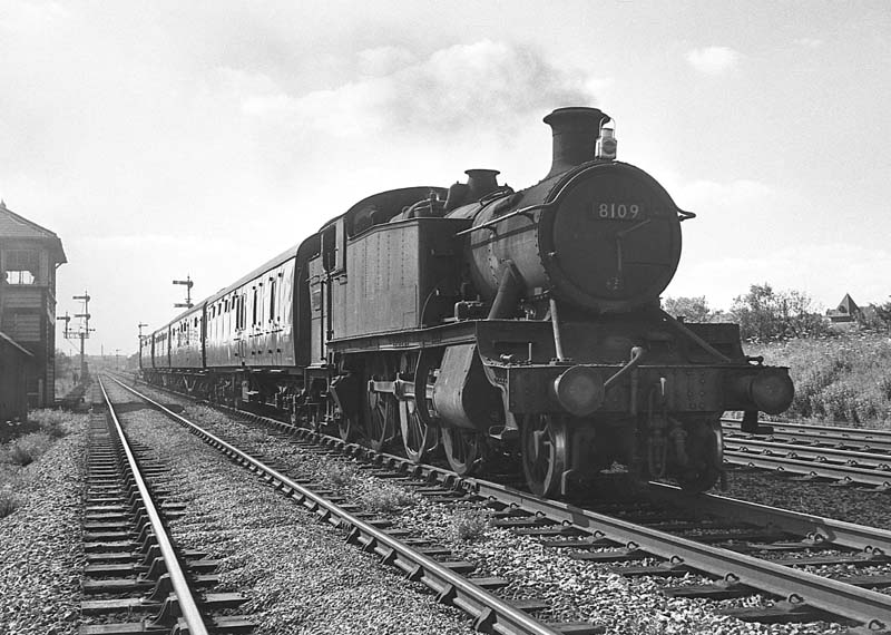Ex-Great Western Railway 81xx class 2-6-2T No 8109 passes Queens Head Signal Box on the Up relief line with a four coach local passenger service on 29th June 1964