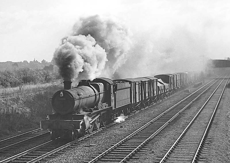Ex-GWR 68xx Class 4-6-0 No 6820 'Kingstone Grange' storms past Queens Head Signal Box with a down freight on 19th September 1964