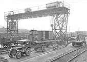 View of the travelling crane loading one of the GWR's mechanised tractor and trailer at Queens Head yard in the early 1930s