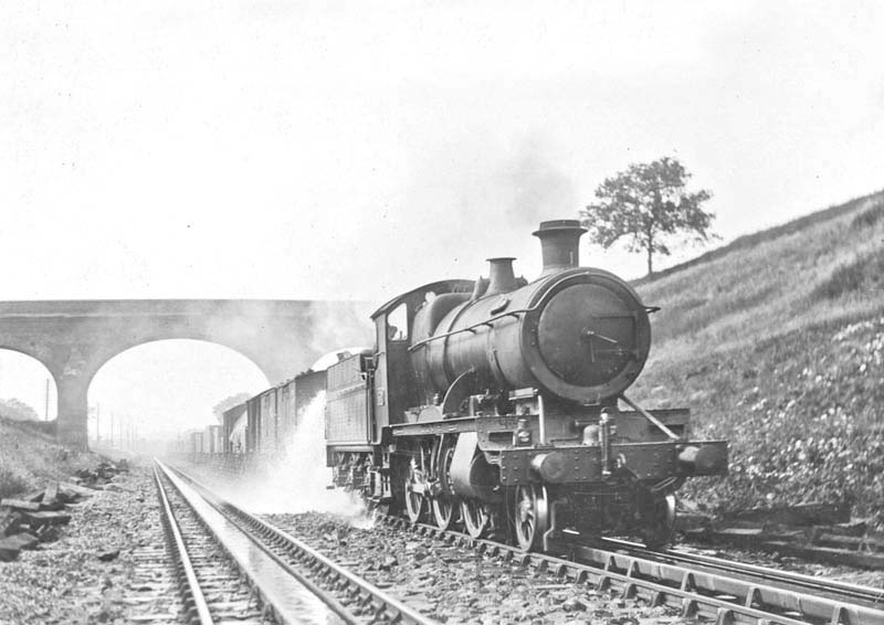 Great Western Railway 2-6-0 43xx class mogul No.4320, with a class H through freight train, drenches the first wagon and the permanent way