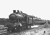 Great Western Railway 2-6-0 43xx class mogul No 6385 picking up water as it heads north with a rake of ex-SECR stock in 1933
