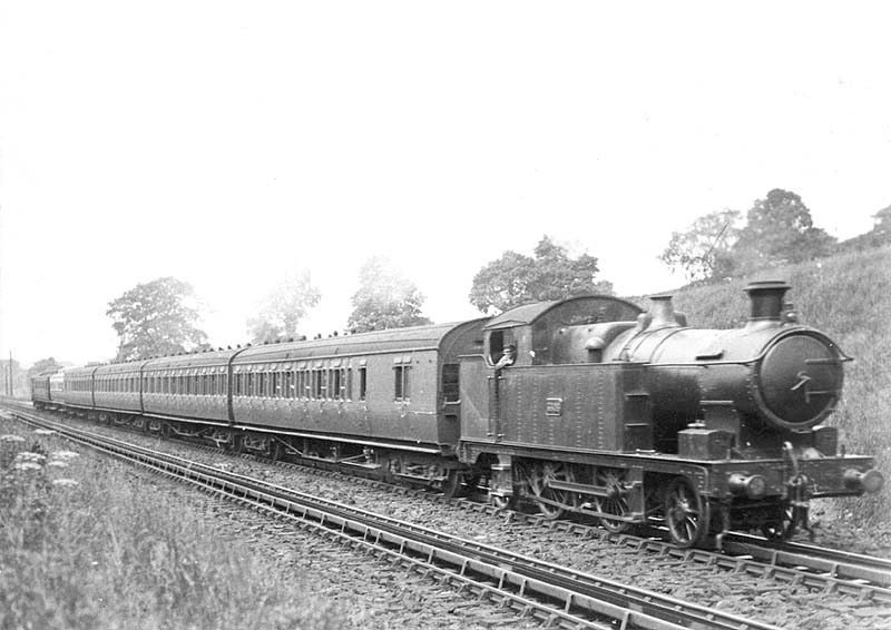 GWR 36xx Class 2-4-2T No 3606 is seen passing over Rowington Troughs on an up local passenger service