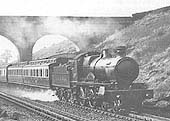 An unknown GWR 4-4-0 County Class locomotive passes over Rowington troughs on an up service