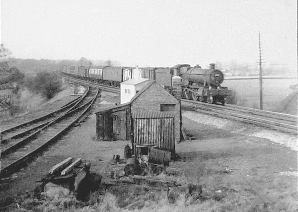 An unidentified ex-GWR 4-6-0 locomotive passes Rowington Junction with a southbound freight service on 3rd March 1961