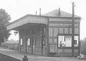 Close up showing the timber framed and clad station building which housed the booking office waiting rooms and toilet facilities