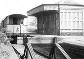View of the station towards the end of the goods service with just a two van train train and guards van standing along side the closed passenger station