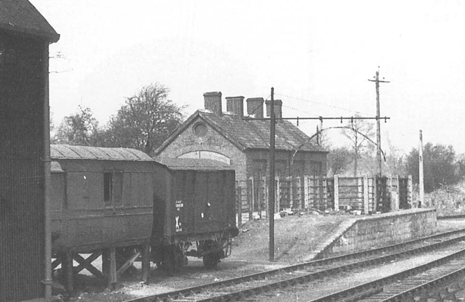 Close up showing the grounded ex-GWR Dean 40 foot passenger bogie brake van and still on its wheels a GWR four-wheel Van