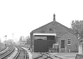 Close up of the goods office and shed secured by a pair of swing gates and the yard shed used to store equipment