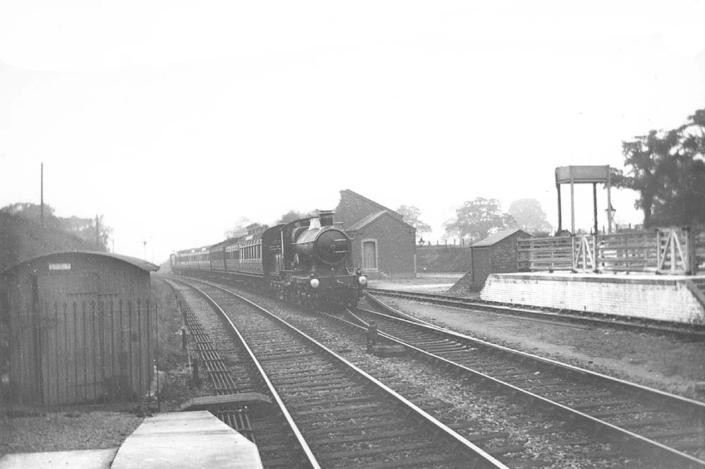 GWR 4-4-0 Bulldog class No 3453 'Dominion of Canada' is seen passing Shirley goods shed and yard on a West of England express service in 1909