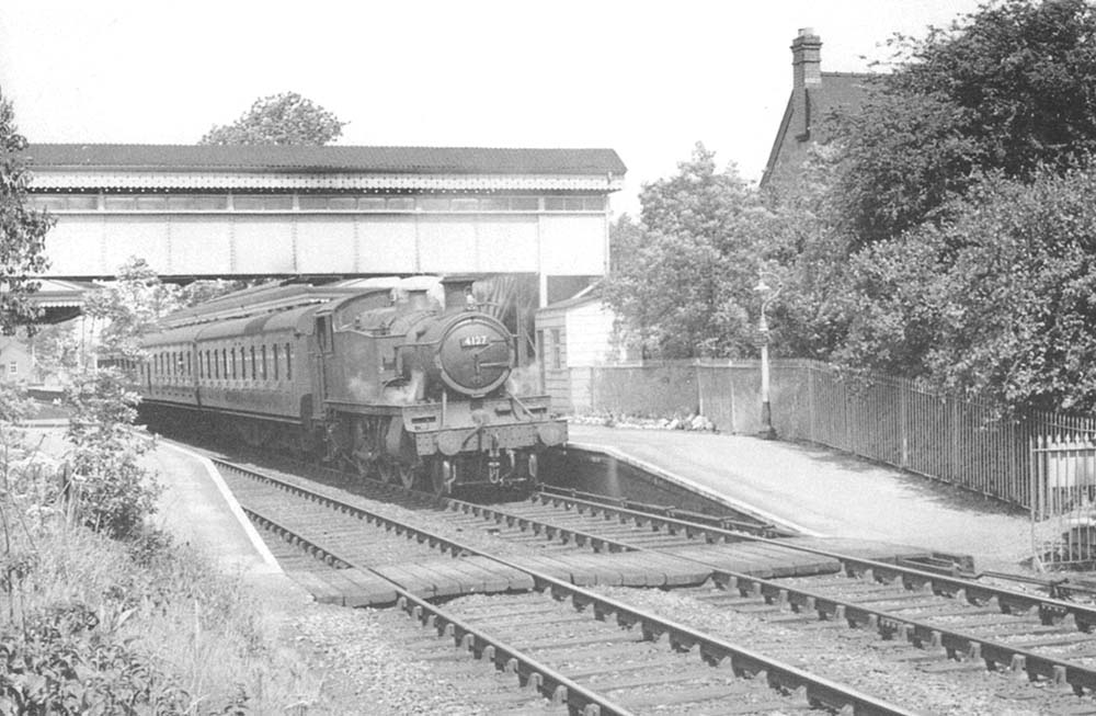 Ex-GWR 2-6-2 No 4127 stands at Shirley station with a down local passenger service on 8th June 1957