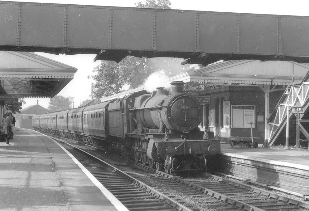 Ex-GWR 4-6-0 Grange class No 6861 'Crynant Grange' is seen at the head of a down West Country express service as it passes through the station