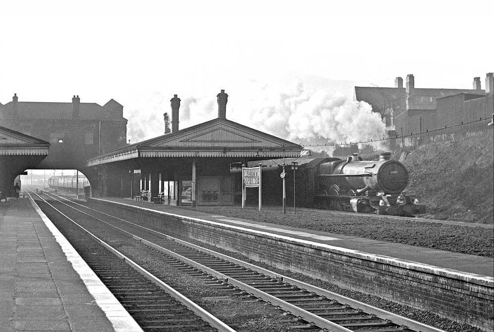 Ex-GWR 4-6-0 No 6000 'King George V' passes through the station's up main platform on 12th April 1962