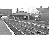 Ex-GWR 4-6-0 No 6000 'King George V' passes through the station's up main platform on 12th April 1962