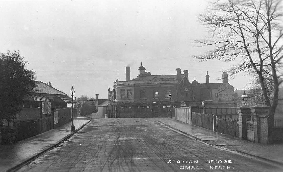 Postcard showing Golden Hillock Road crossing the station bridge at Small Heath with the Station Booking Office on the left