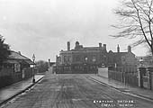 Postcard showing Golden Hillock Road crossing the station bridge at Small Heath with the Station Booking Office on the left