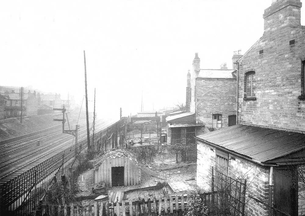 Looking in the direction of Birmingham with the main and relief lines to be seen on the left and a wartime 'Anderson' shelter in the garden