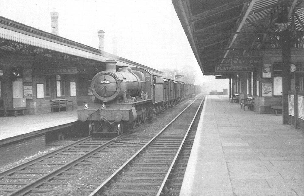 GWR 4-6-0 No 5950 Wardley Hall is seen at the head of a down perishables express goods service passing through Solihull station
