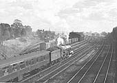 GWR 4-6-0 No 6022 'King Edward III' is seen at the head of an up express service as it restarts from a signal check north of Solihull station
