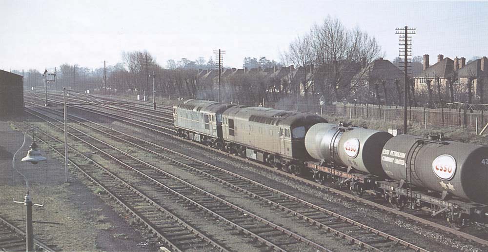 British Railways Type 3 Diesel locomotives No D6534 and D6506 pass through Solihull on an empty up oil train on 11th April 1964