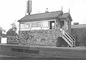View of the original signal box shortly before its demolition with the old goods shed and yard behind
