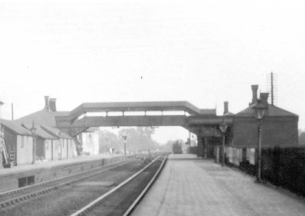 Close up showing the down platform and buildings with an unknown GWR locomotive standing in the down refuge siding