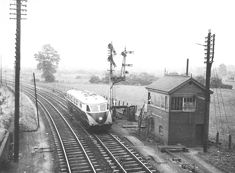 An unidentified Great Western Railway Diesel Railcar is seen passing Stratford on Avon West Signal Box on the up 9:10am  Cardiff to Snow Hill service
