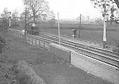 An unidentified GWR 2-4-2T 36xx class locomotive runs light engine towards Stratford on Avon West Signal Box with the up refuge siding behind