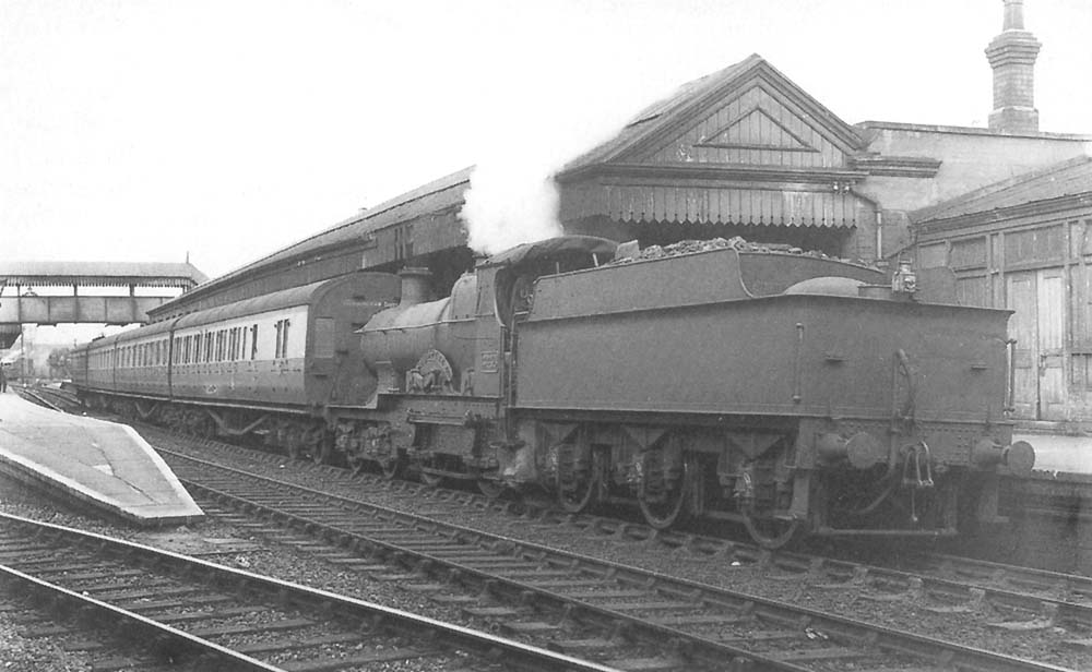 GWR 4-4-0 Bulldog class No 3446 'Goldfinch' is seen standing at the down platform whilst running tender first on a local passenger service