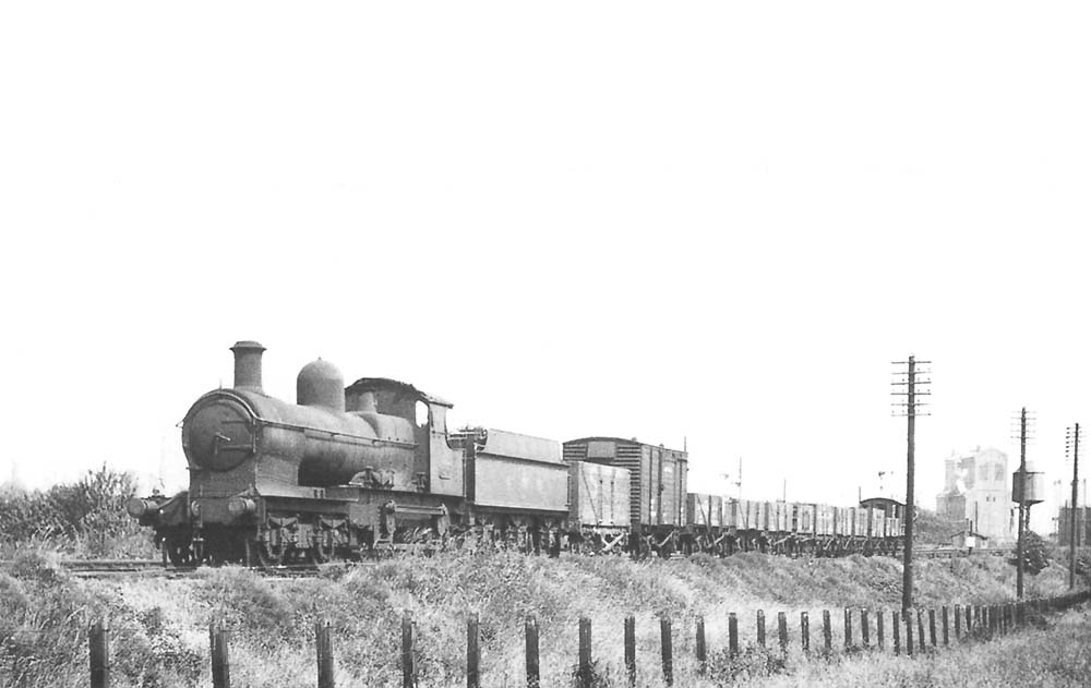 GWR 4-4-0 Earl class No 3210, formerly 'Earl Cairns' is seen leaving Stratford on Avon at the head of a short up goods on 26th June 1943