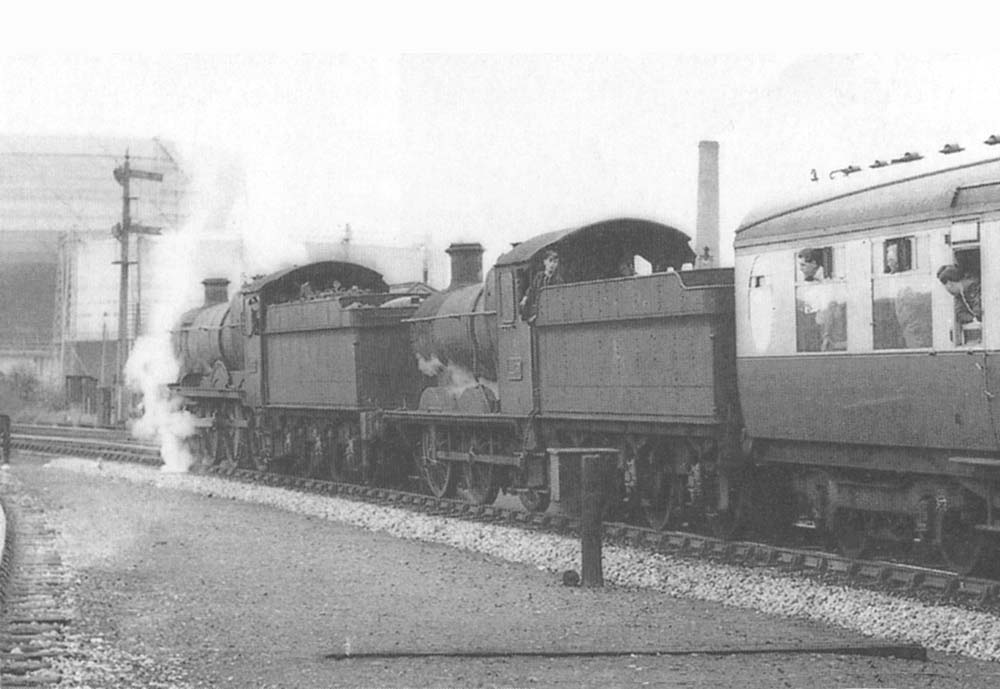 An unidentified ex-GWR 4-6-0 Grange class locomotive is assisted by ex-GWR 0-6-0 No 2257 to help climb the long gradient to Earlswood