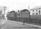 An unidentified ex-GWR 4-6-0 Grange class locomotive is assisted by ex-GWR 0-6-0 No 2257 to help climb the long gradient to Earlswood