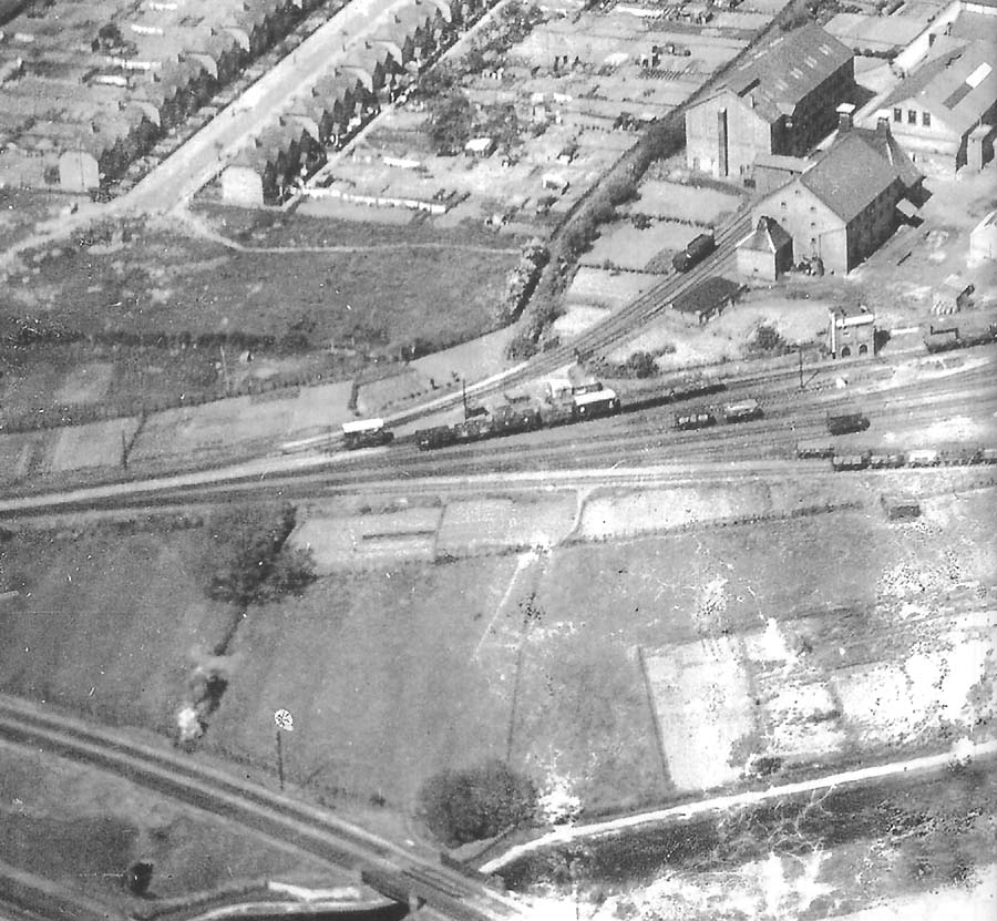 View of the throat to the sidings at Stratford on Avon station's goods yard, Flower & Sons Brewery and the local gas works