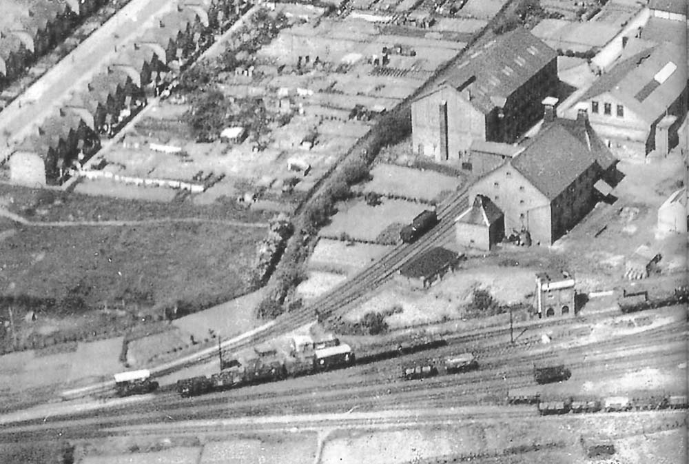 Close up showing Flower & Sons sidings, the barley house and bottling plant with the GWR's water tank at the throat to the yard in the near distance