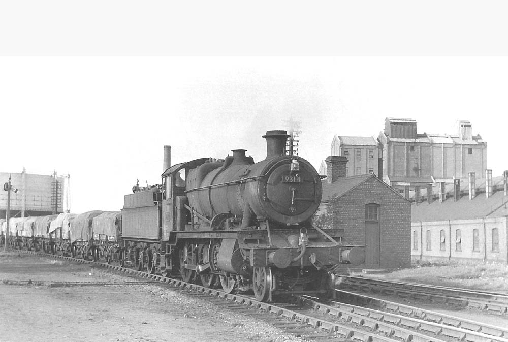 Ex-GWR 2-6-0 No 9314 is seen with a down freight passing Stratford on Avon shed on 29th April 1958