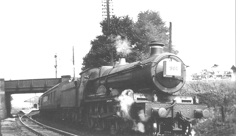 GWR 4-6-0 Saint Class No 2981 'Ivanhoe' stands at signals opposite Stratford on Avon West Signal Box with a southbound troop train circa 1934