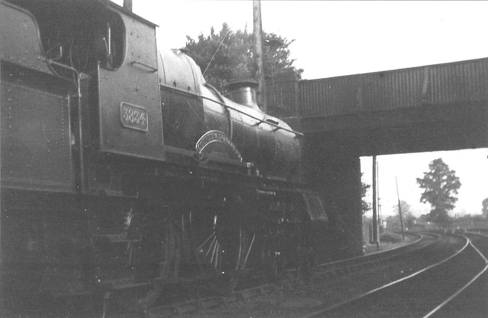 GWR 4-4-0 County class No 3834 'County of Somerset' stands in the station with a southbound train on 6th July 1933