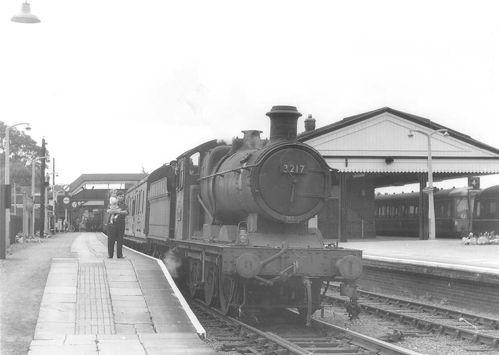 Ex-GWR 0-6-0 2251 class No 3217 is seen at the Birmingham end of the down platform at the head of a local passenger service to Birmingham