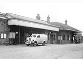 An external view of Stratford on Avon station in the early days of its ownership by British Railways with a Morris Van parked outside