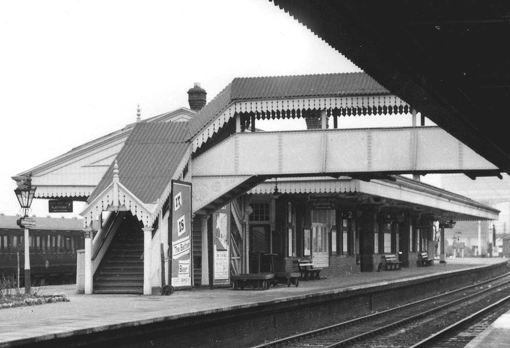 Close up showing the island platform's building which housed substantial passenger facilities and the steps of the passenger footbridge