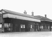 Exterior view of Stratford on Avon station with the parcel booking office to the right of the gated entrance and booking office to the right