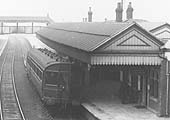 Close up showing the auto-trailer standing at the down platform whilst staff and passengers wait to board the service to Honeybourne