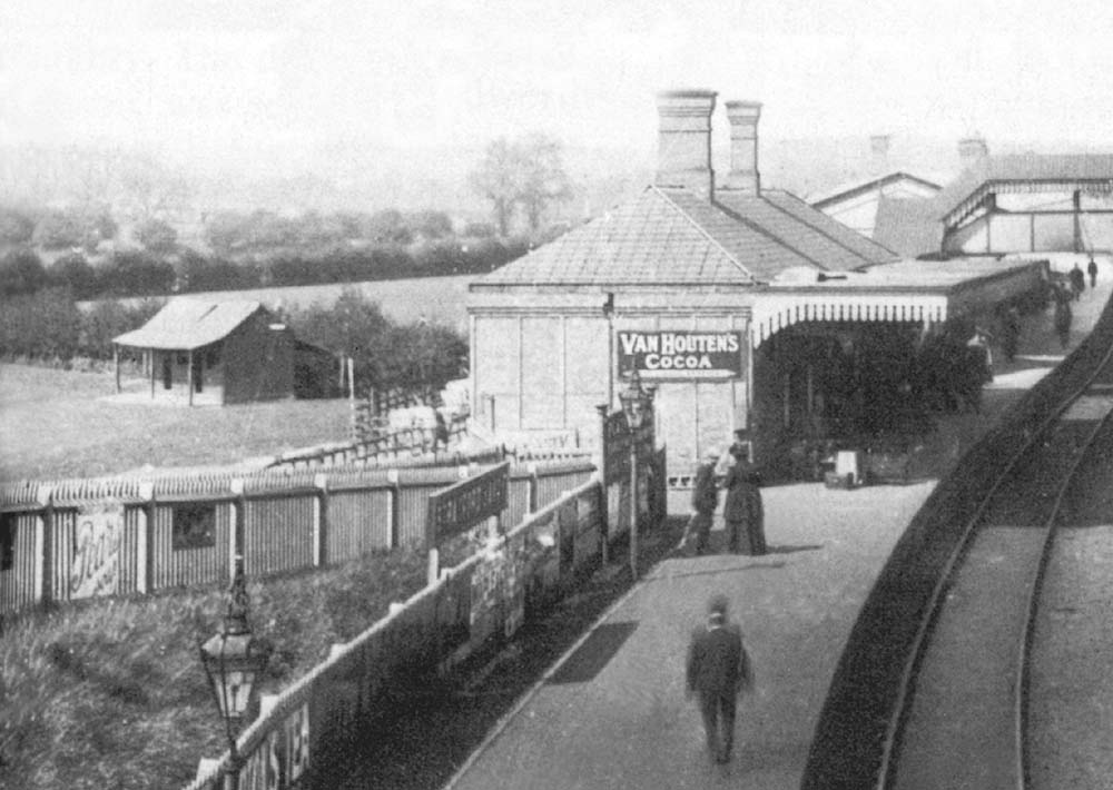 Close up of Stratford on Avon's up platform and building whilst to the left can be seen a footpath running from Alcester Road to the platform