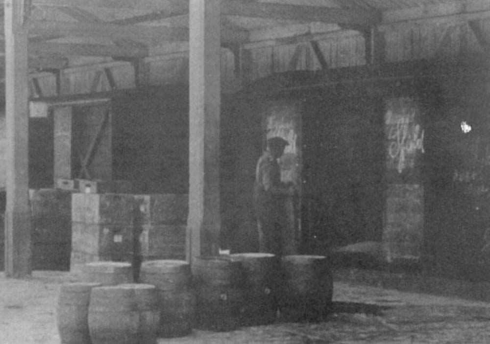 Close up showing the loading into a covered van of the different types of beer shipped by Flowers Brewery, casks of ales and crates of bottled beers