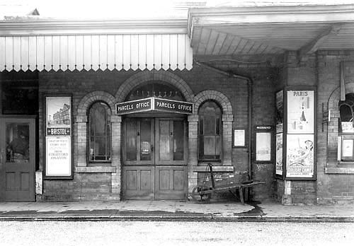 View of the entrance to the Parcels Office from the down platform showing the triangular sign suspended above the doorway