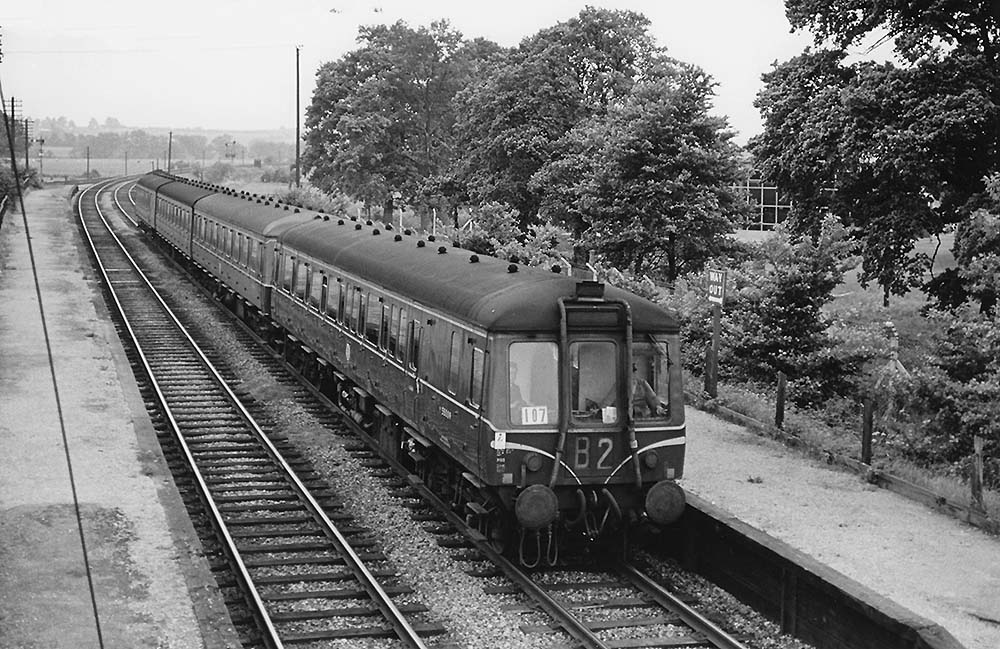 A northbound DMU passes through Stratford Racecourse Platform on the 17:50pm Worcester Shrub Hill to Stratford on Avon service on 23rd May 1964