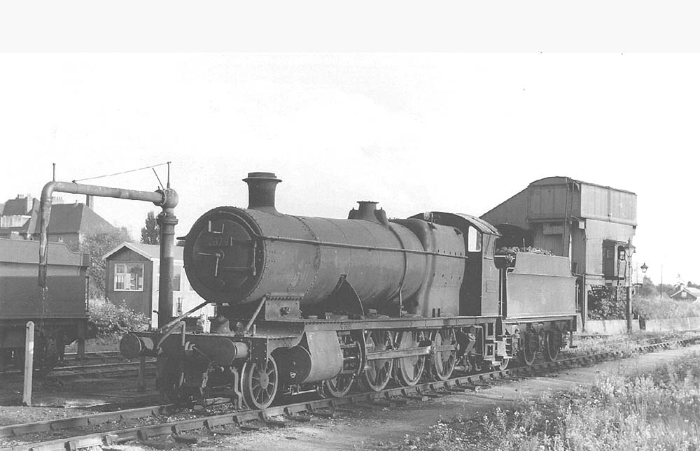 Ex-GWR 2-8-0 No 2879 stands in front of the shed adjacent to the water column on 16th August 1959