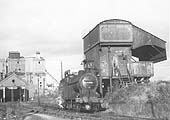 Ex-LMS 0-6-0 4F No 44353 is bearing a 2E shed plate as it stands at the GWR coaling stage for coaling and watering before returning to the SMJ