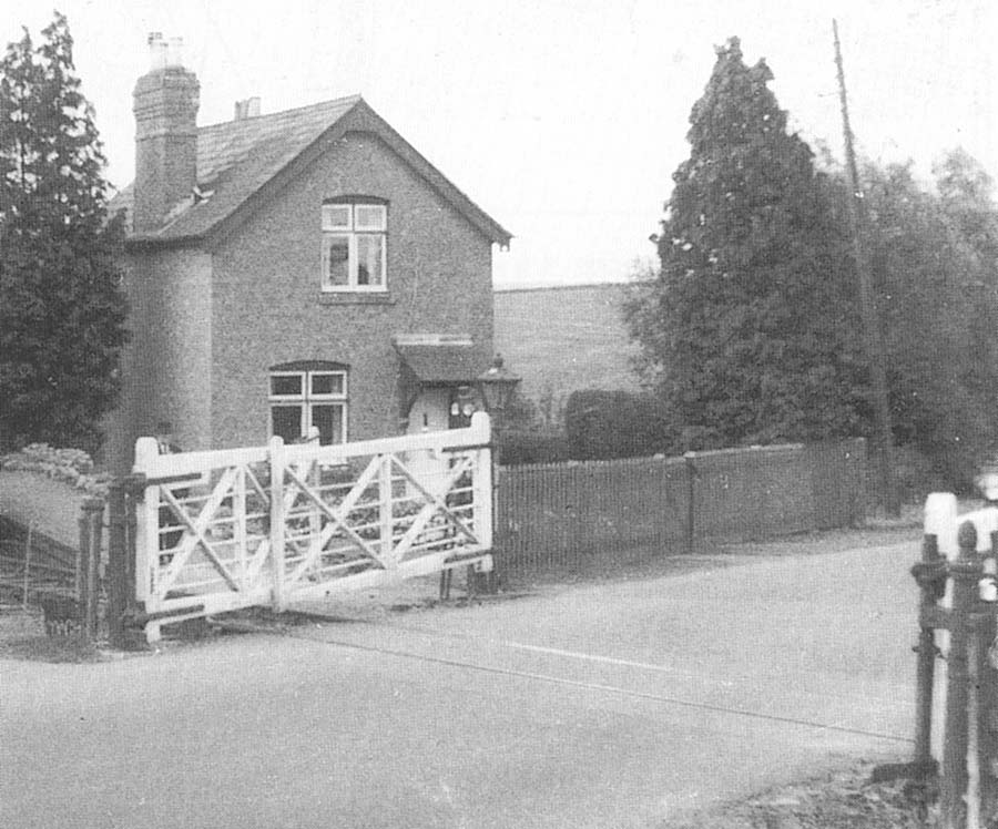 A view of Stretton-on-Fosse Level Crossing showing the overlapping gates and the adjacent station masters house