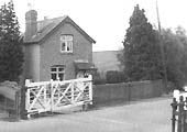 A view of Stretton-on-Fosse Level Crossing showing the overlapping gates and the adjacent station masters house
