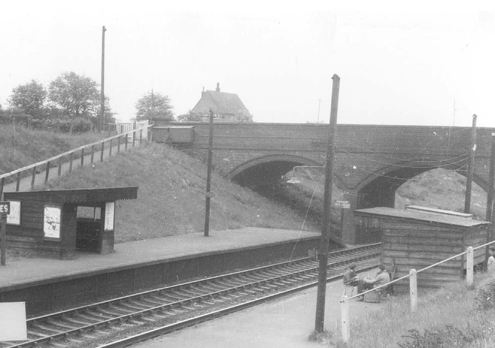 Close up showing the two simple timber-framed and clad passenger waiting room on each of The Lakes' short platforms